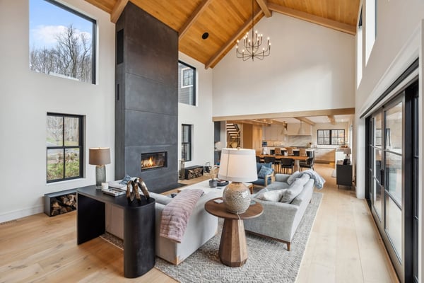 Stowe Woods great room with vaulted ceiling, fireplace, and open kitchen