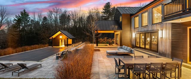 Stowe Woods outdoor patio and pool at sunset with vivid pink and orange sky
